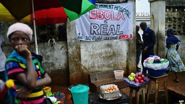 A sign warning of the dangers of Ebola outside a government hospital in Freetown on August 13