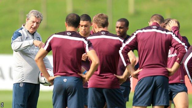 England manager Roy Hodgson (left) talks to his players