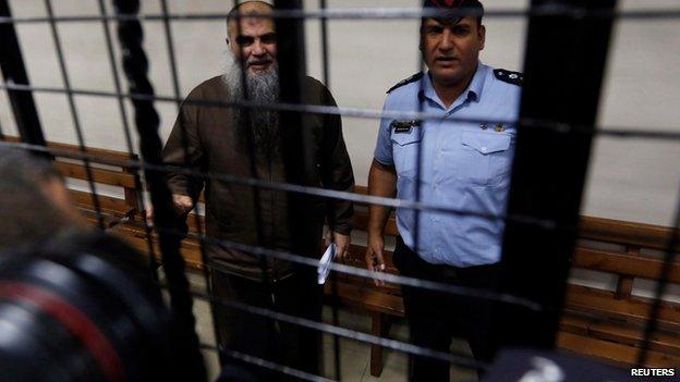 Photographers take pictures of Abu Qatada in court in Amman, Jordan, on 7 September 2014