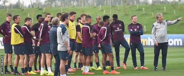 Roy Hodgson takes training with assistants Gary Neville and Captain Wayne Rooney