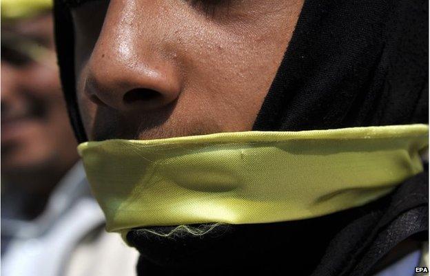 A supporter of the Shiite Houthi movement covers his mouth with a yellow ribbon, Sanaa, 7 September