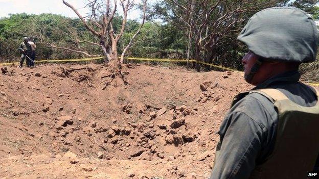 A Nicaraguan soldier checks the site where a meteorite struck on 7 September, 2014 in Managua.