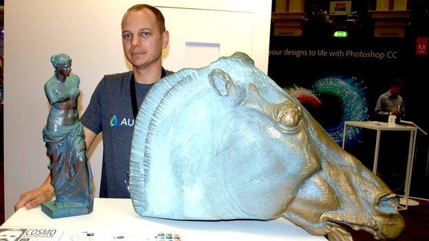 Autodesk's Jesse Harrington with 3D printed sculptures made on a Makerbot printer