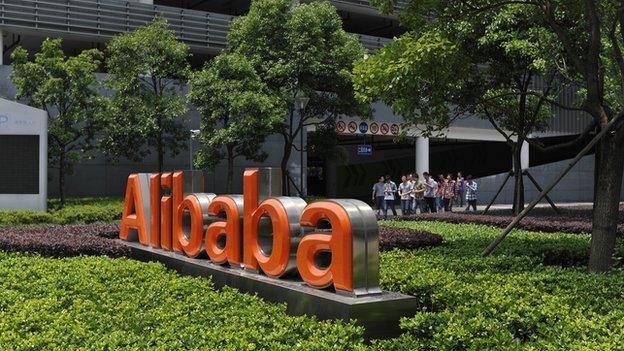 Chinese workers walk out from the Alibaba head office building in Hangzhou, in eastern China's Zhejiang province on 21 May 2012.