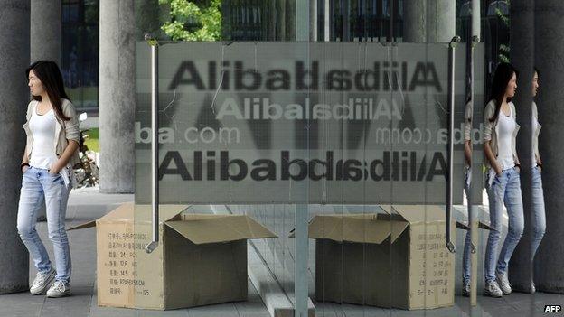 A Chinese woman walks out from the Alibaba head office building in Hangzhou, in eastern China's Zhejiang province on 21 May 2012.