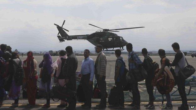 Tourists who were rescued by the army from the flooded areas wait to be transported to Jammu at an air force base in Srinagar, India, Monday, Sept. 8, 2014