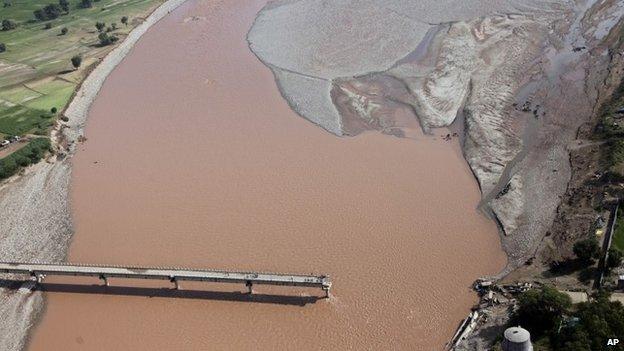 An aerial view shows a damaged bridge across the River Tawi at Mandal village on the outskirts of Jammu, India, Monday, Sept. 8, 2014.