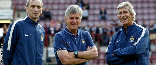 Man City coaches Ruben Cousillas (left) and Brian Kidd (right) with boss Manuel Pellegrini