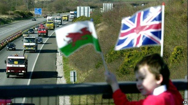 Boy waving Welsh and union flag