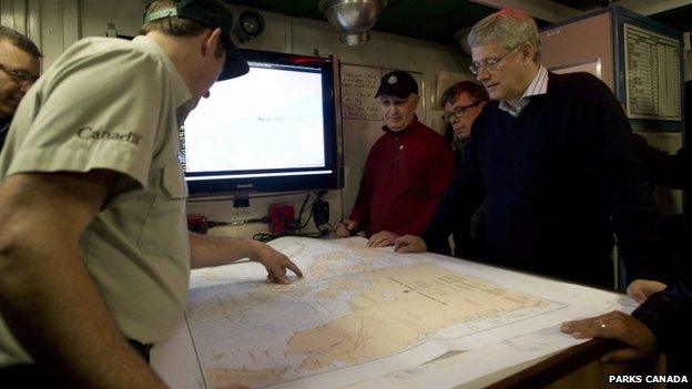 Canadian Prime Minister Stephen Harper is briefed on the ship's location