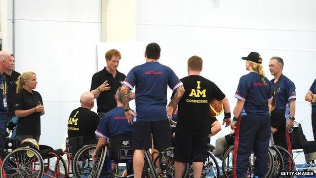 Prince Harry speaking to competitors