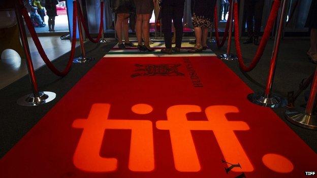 People standing on a red carpet