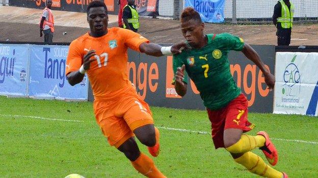 Ivory Coast's Serge Aurier and Cameroon's Clinton Njie vie for the ball