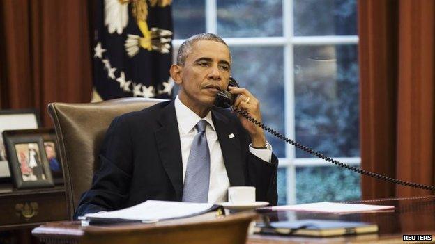 Barack Obama speaks on the phone with Saudi Arabia's King Abdullah from the Oval Office of the White House in Washington September 10