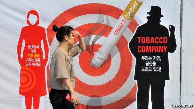 A woman walks past a poster during a campaign marking the World No Tobacco Day in Seoul on 31 May 2012.