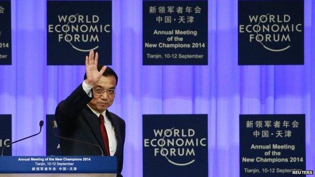 Chinese Premier Li Keqiang waves to attendants after making a speech during the World Economic Forum