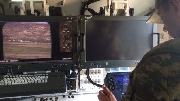 A Turkish serviceman monitors border