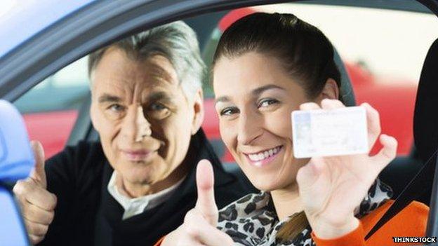 A driver holding up her licence