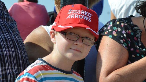 Young boy wearing Red Arrows cap