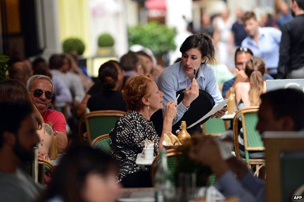 Waitress serves table