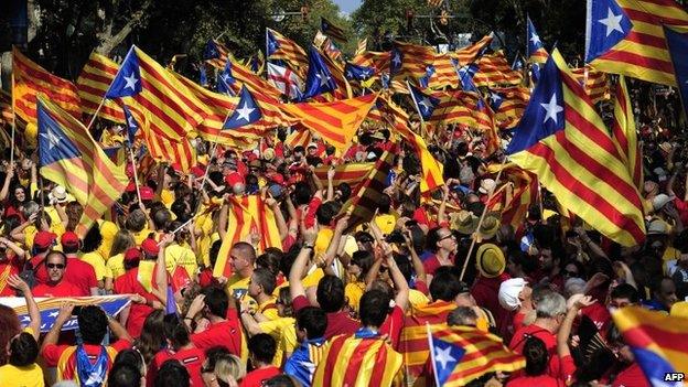 Catalans hold Catalonia pro-independence flags during celebrations of Catalonia National Day (Diada) in Barcelona on 11 September 2014