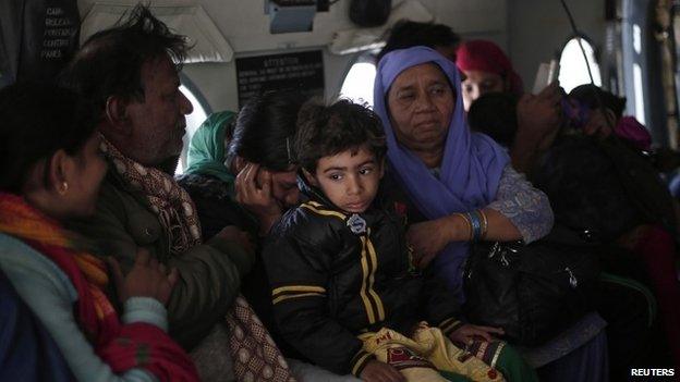 A Kashmiri family sits inside an Indian Air Force"s (IAF) helicopter after being rescued from a flooded area in Srinagar September 11, 2014.