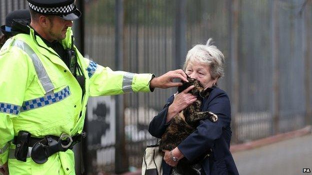 Woman, cat and policeman