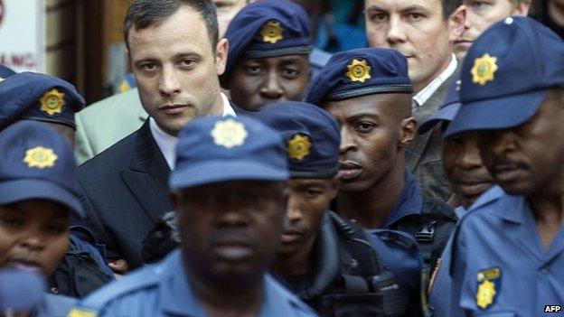 South African Paralympian athlete Oscar Pistorius leaves the the High Court in Pretoria on 12 September 2014