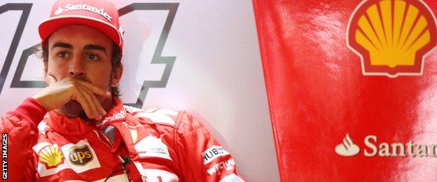 Fernando Alonso of Spain and Ferrari looks on from the team garage during Practice ahead of the F1 Grand Prix of Italy at Autodromo di Monza on September 5, 2014 in Monza.