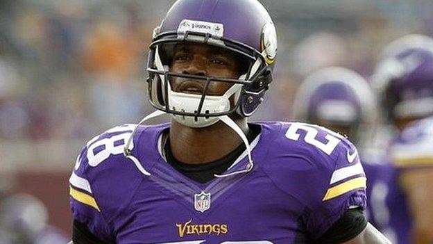 Minnesota Vikings player Adrian Peterson warms up before a game against the Arizona Cardinals in Minneapolis - 16 August 2014