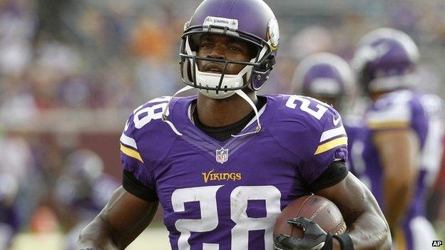 Minnesota Vikings player Adrian Peterson warms up before a game against the Arizona Cardinals in Minneapolis - 16 August 2014