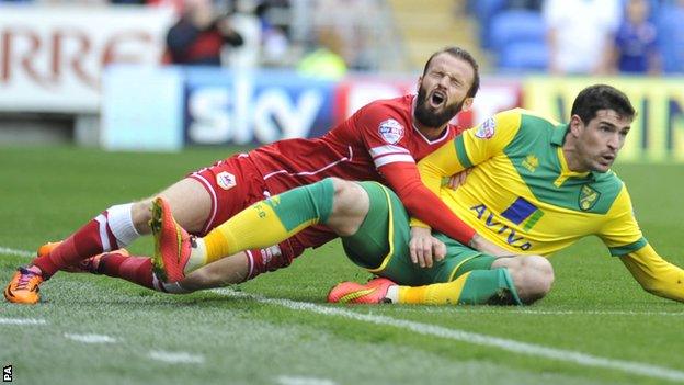 Cardiff City's John Brayford and Norwich City's Kyle Lafferty battle for the ball