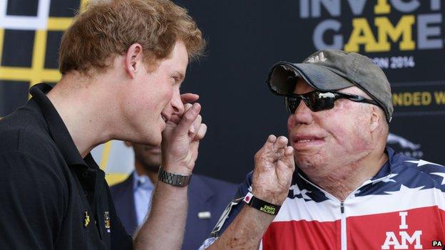 Prince Harry chats with Sgt Israel Del Toro, of the US team