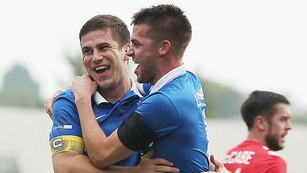 Mark Haughey is embraced by Stephen Lowry after scoring Linfield's winner against Warrenpoint