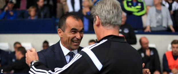 West Brom boss Alan Irvine (right) swaps niceties with Everton counterpart Roberto Martinez before the game