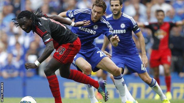 Swansea striker Bafetimbi Gomis vies with Chelsea midfielder Nemanja Matic