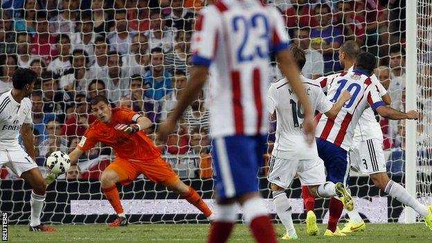 Atletico Madrid's Arda Turan scores