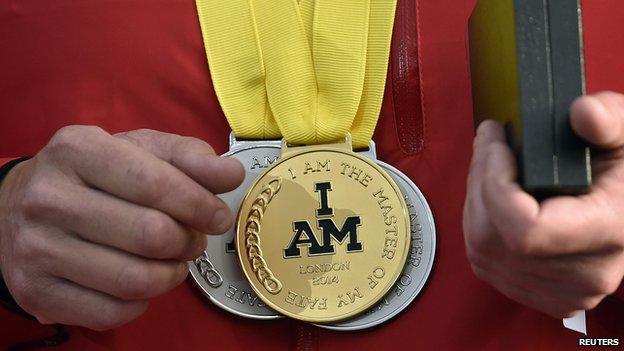 An athlete wears an Invictus Games medal