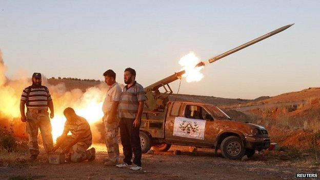 Free Syrian Army fighters launch a rocket towards Hama military airport in Syria - 25 July 2014