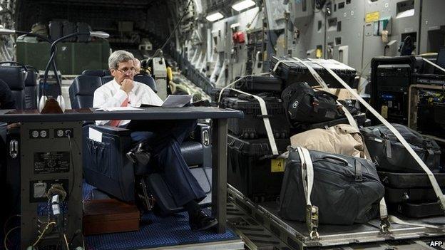 US Secretary of State John Kerry looks over papers while flying from Jordan to Iraq - 10 September 2014