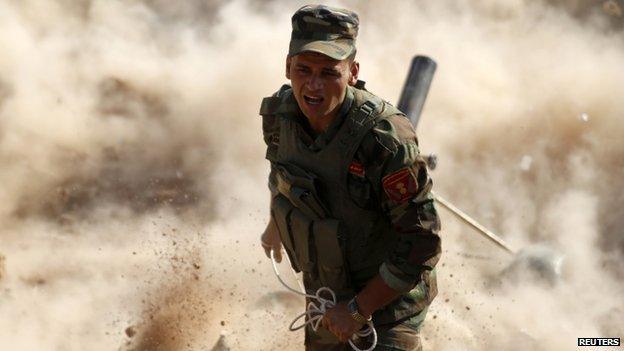 A Kurdish Peshmerga fighter launches mortar shells near Mosul. Photo: 15 September 2014