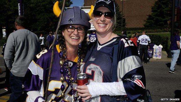 A Minnesota Vikings fan carries a stick before their game on Sunday.