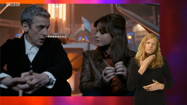 A still from an episode of Doctor Who including an in-vision signer in the bottom right-hand corner