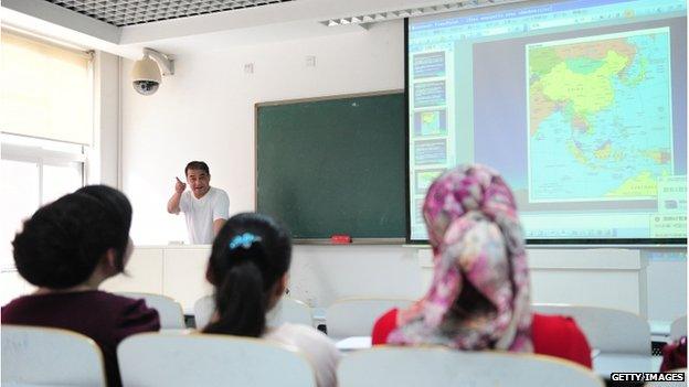 Ilham Tohti lectures in a classroom in Beijing on 12 June 2010