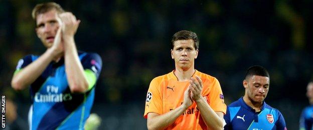 Arsenal players react at the final whistle after losing to Borussia Dortmund in the Champions League