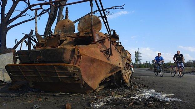 Cyclists pass destroyed Ukrainian army convoy 16 September 2014