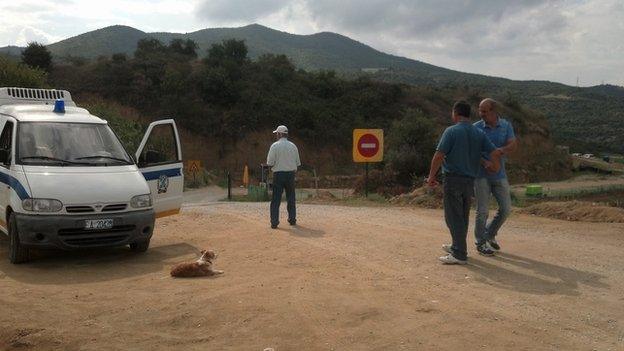 Police vehicle guarding the dig site