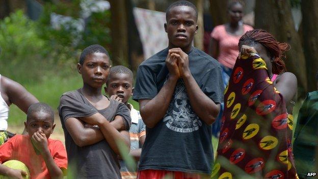 Liberians watch removal of Ebola victim's body