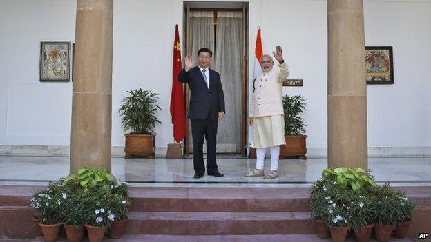 Indian Prime Minister Narendra Modi and visiting Chinese President Xi Jinping wave to the media before a meeting in New Delhi, India, Thursday, Sept. 18, 2014.