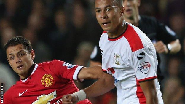 Dele Alli (left) tussles with Manchester United's Javier Hernandez